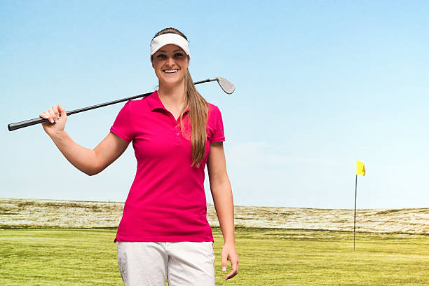 istock Female golfer standing in field 518204110