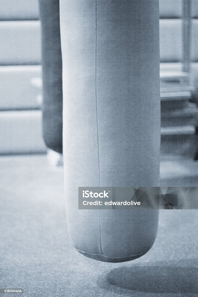 Punch kick bag in boxing gym Punch and kick punchbag in boxing, kickboxing, martial arts, MMA and gym, bodybuilding and weight training weights gym. Backgrounds Stock Photo