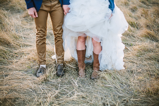 Bride In Cowboy Boots And Groom In Brown Shoes Stock Photo - Download Image  Now - Wedding, Rural Scene, Hipster Culture - iStock