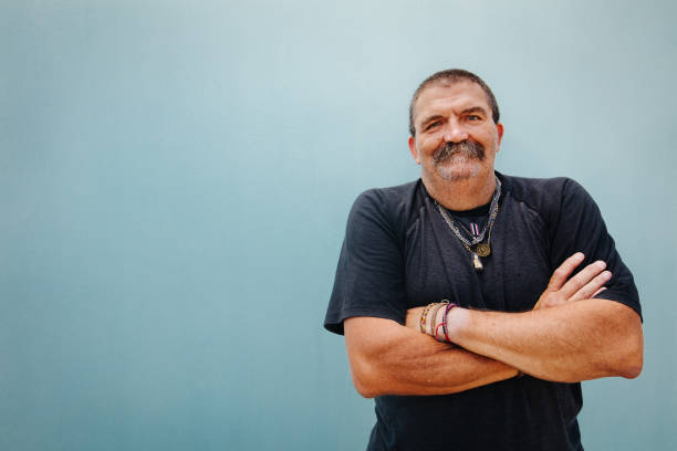Portrait of smiling senior man with crossed arms
