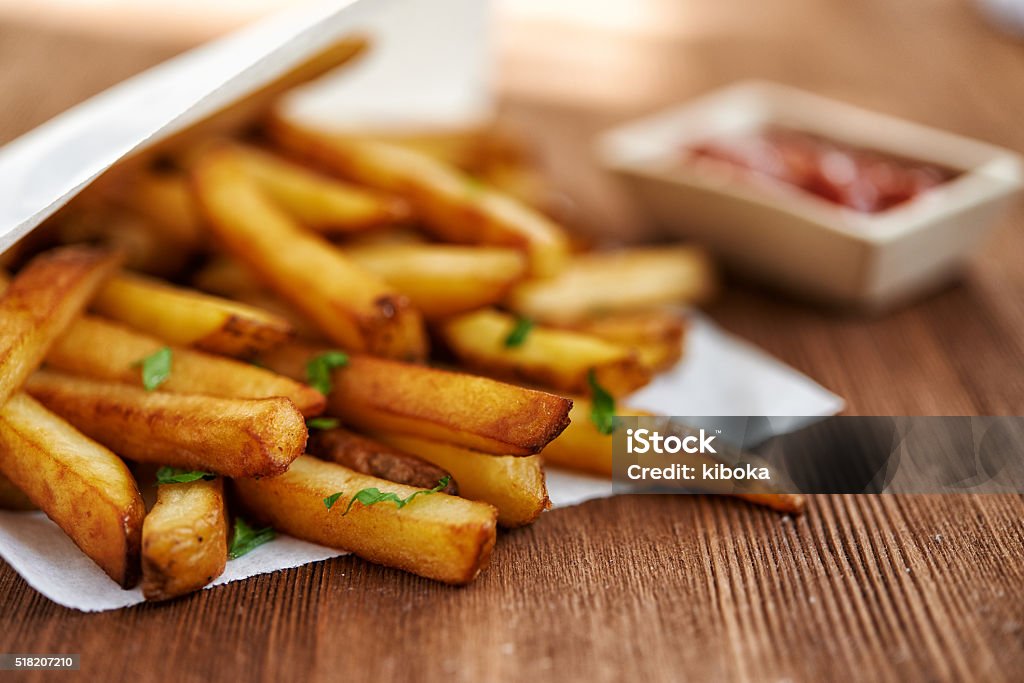 french fries and ketchup french fries in paper bag and red sauce. selective focus French Culture Stock Photo