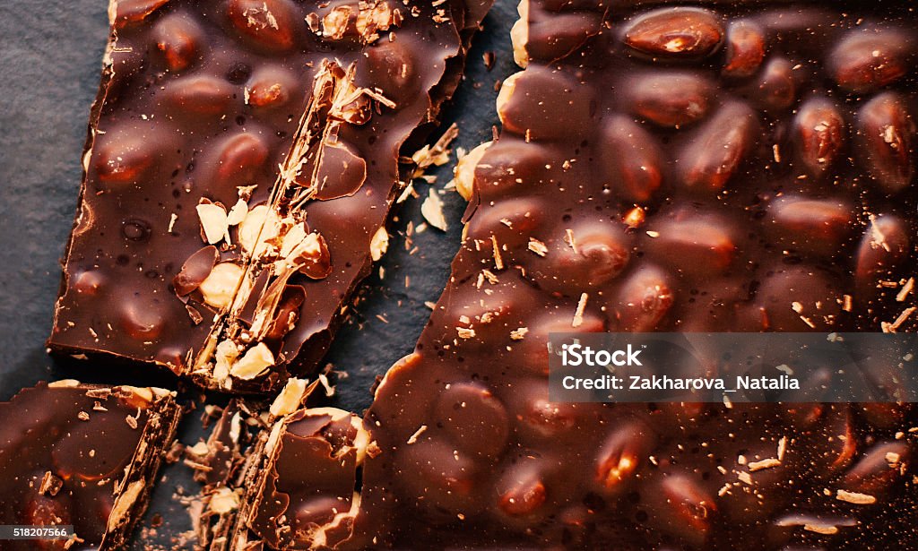 Chopped chocolate Chopped chocolate bar background. Chocolate background/ nut chocolate. Chocolate Black Background Stock Photo