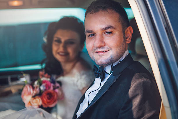 istock Bride and groom in a car 518208928