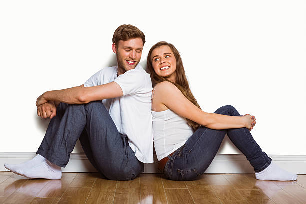 istock Young couple sitting on floor 518220303