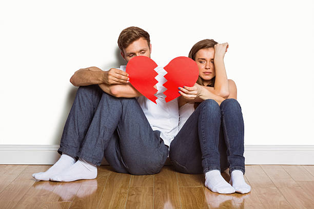 istock Young couple holding broken heart 518220433