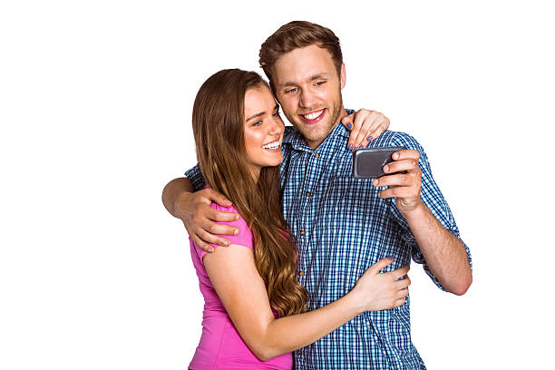 istock Cheerful young couple taking selfie with smart phone 518220579