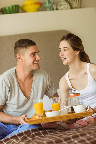 istock Cute couple having breakfast in bed 518220791