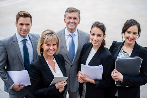 Group of successful business people looking happy