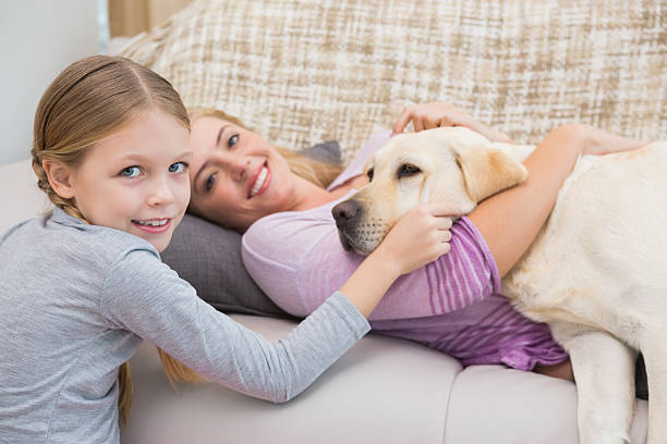 istock Mother and daughter with pet labrador 518220857