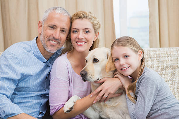 istock Parents and daughter with pet labrador 518220865