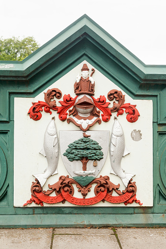 The decoration of a historic bridge shows a coat of arms for various forms of commerce.