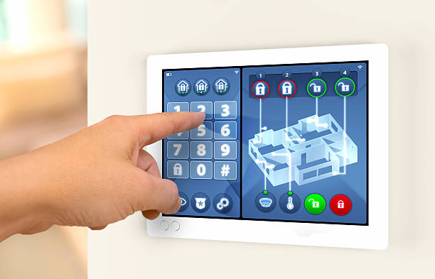 Smart home automation: engaging house alarm security system Smart home automation: wall display showing house alarm security system with secret code number keypad and apartment map with sensors and lock status. Hands pointing at touch display, digiting code. burglar alarm stock pictures, royalty-free photos & images