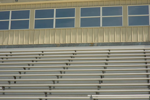 Stadium Bleachers and Skybox at Sporting Event this photo is of Stadium Bleachers and Skybox at Sporting Event. the sporting event could be american football, baseball, basketball, soccer, field hockey, polo, track and field, bull riding, horse riding. the photo was taken outside in natural sunlight.  school bleachers stock pictures, royalty-free photos & images