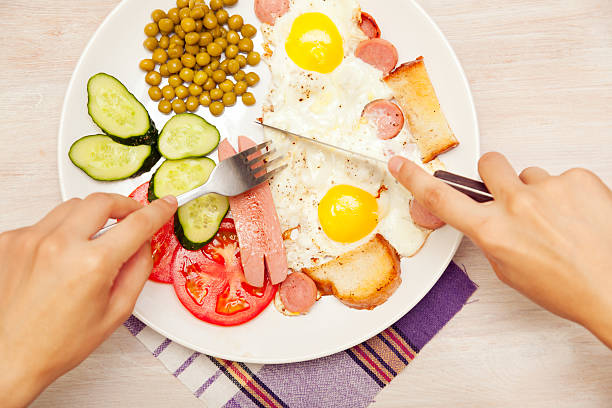 istock fried eggs eggs with sausages and vegetables for breakfast, top 518222407