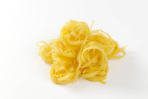 istock Nests of dry pasta tagliatelle 518222644