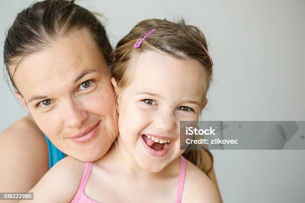 Portrait Of Mother And Daughter Embracing Smiling Stock Photo - Download Image Now - Mother, Look-alike, Child