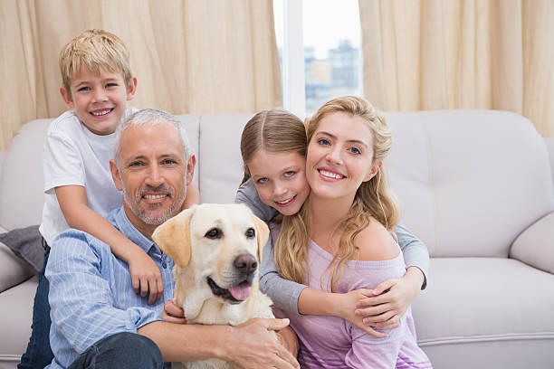 istock Parents and children on rug with labrador 518223211