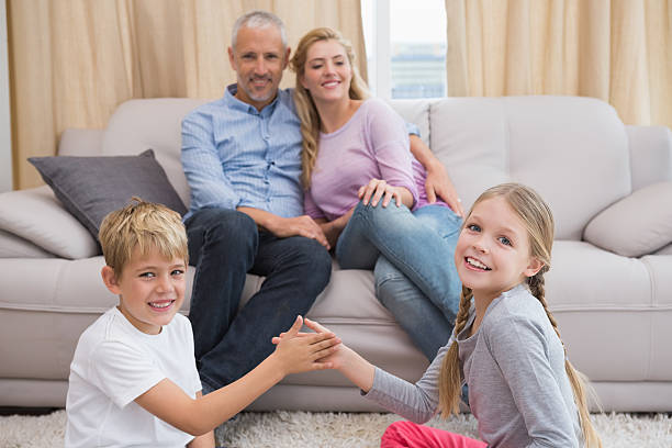 istock Happy parents with their children on floor 518223221