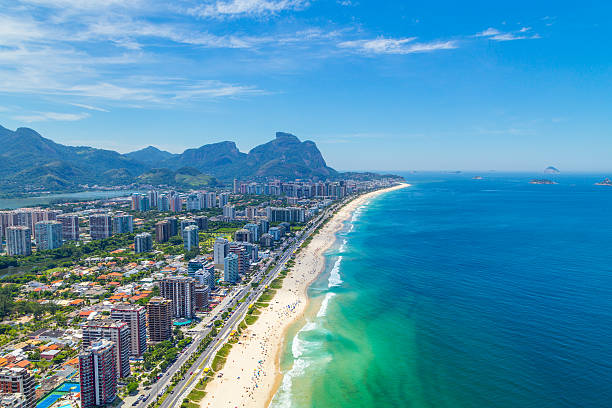 Aerial View of the Barra Beach in Rio de Janeiro Aerial View of the Barra da Tijuca Beach in Rio de Janeiro, Brazil. One of the more popular beaches in Rio on the summer, it's a famous spot for surf competitions and other waterspouts. barra beach stock pictures, royalty-free photos & images