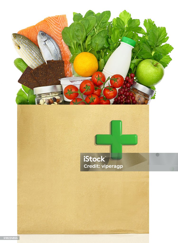 Paper bag with medical green cross filled with healthy foods Bag Stock Photo