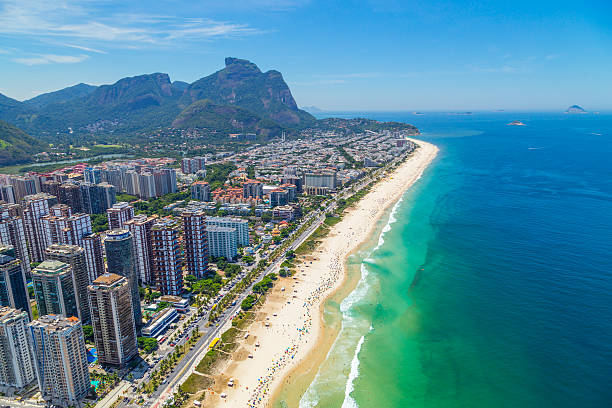 Aerial View of the Barra Beach in Rio de Janeiro Aerial View of the Barra da Tijuca Beach in Rio de Janeiro, Brazil. One of the more popular beaches in Rio on the summer, it's a famous spot for surf competitions and other waterspouts. barra beach stock pictures, royalty-free photos & images