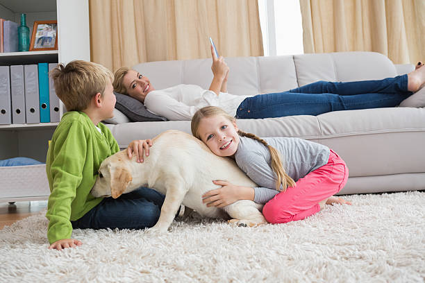 istock Cute silblings with their puppy on rug 518225225