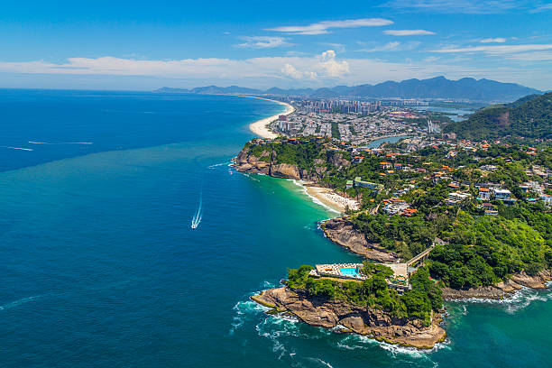 Aerial View of the Barra Beach in Rio de Janeiro Aerial View of the Barra da Tijuca Beach in Rio de Janeiro, Brazil. One of the more popular beaches in Rio on the summer, it's a famous spot for surf competitions and other waterspouts. barra beach stock pictures, royalty-free photos & images