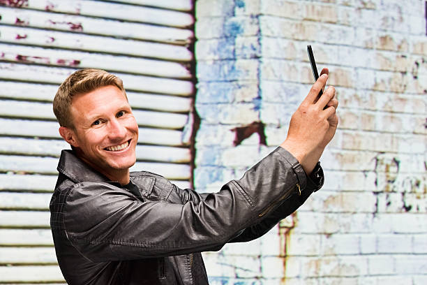 istock Smiling man taking a selfie outdoor 518226836