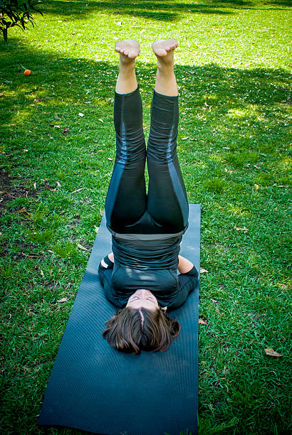 istock Beautiful woman practicing yoga in the park 518227572