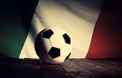 Flag of Italy with football on wooden boards as the background. Vintage Style.