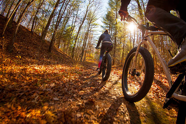 istock Riding mountain bikes through the woods on a fall day 518229294