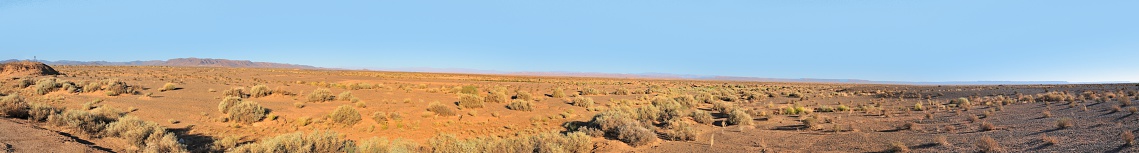 Between the cities of El Jorf and Tsar Touring, Morocco on Route 702, we encounter some of the bleakest land on Earth as seen in this panorama view. There is a spotting scope and tripod standing on a high point at the very left of the image to give some sense of scale