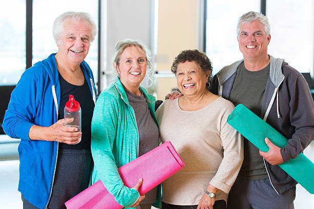 istock Senior couples prepare for yoga class 518230842