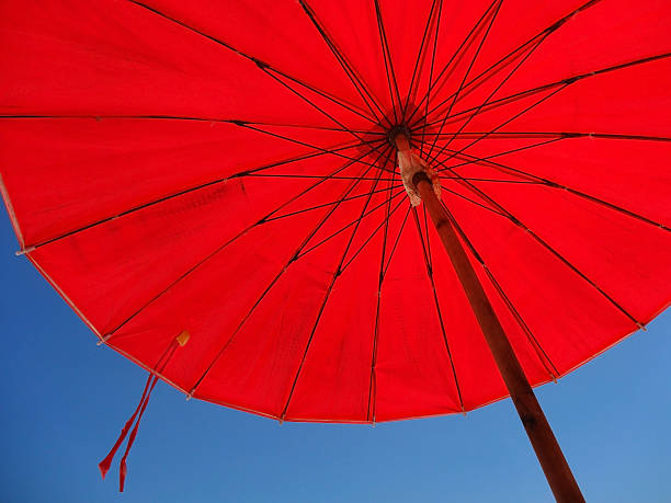 istock Red beach umbrella and blue sky 518231896