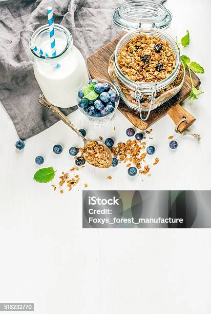 Healthy Breakfast Ingrediens Homemade Granola In Open Glass Jar Milk Stock Photo - Download Image Now