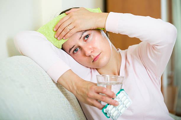 istock Woman with headache at home 518232840