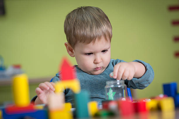 istock Kid is playing with toys in nursery 518233396