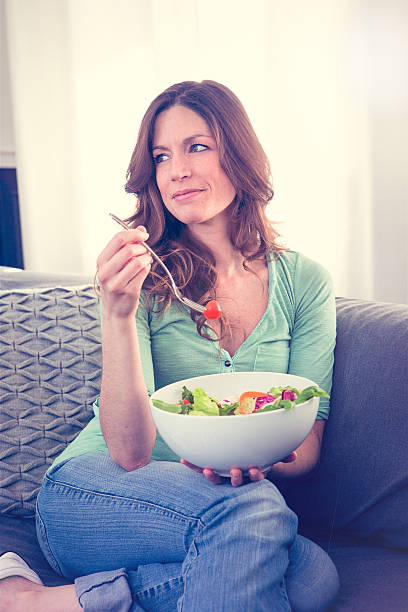 istock woman eating salad 518244042