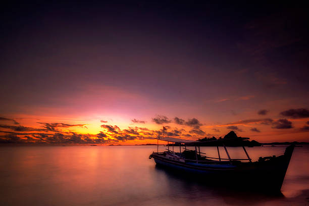 istock Morning dramatic sunrise small boat 518244956