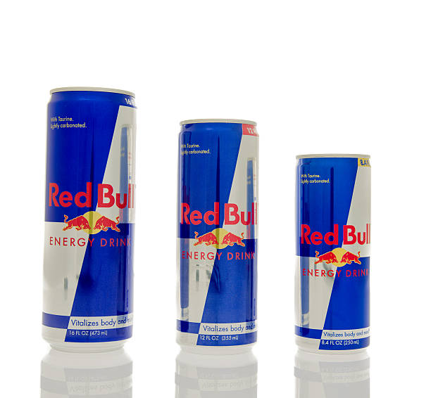 Red Bull  Winneconne, WI, USA - 14 March 2016: Three different sizes of Red Bull energy drink. red bull mini stock pictures, royalty-free photos & images