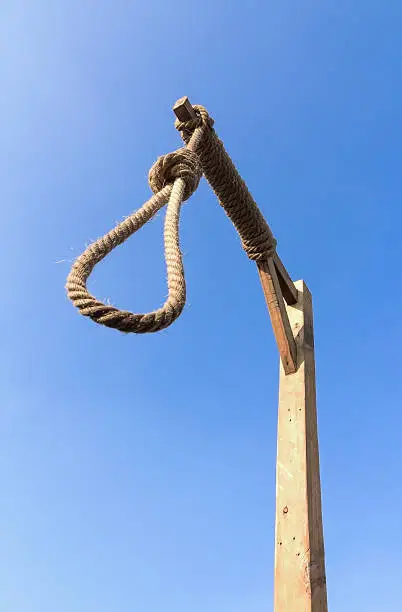 Gallows and hangman noose against a blue sky