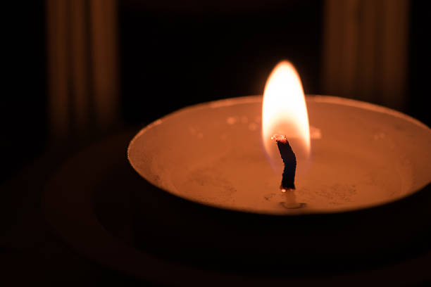 istock Burning candles on dark background - close up (Selective focus) 518249558
