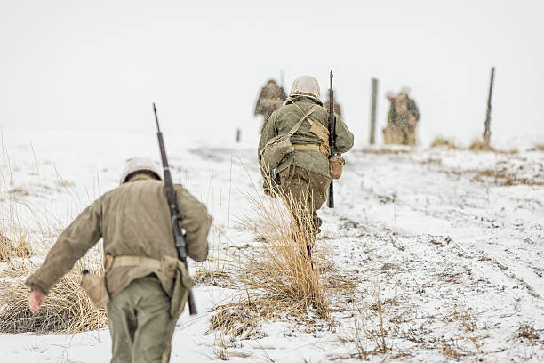 United States Army WWII soldiers marching in the snow