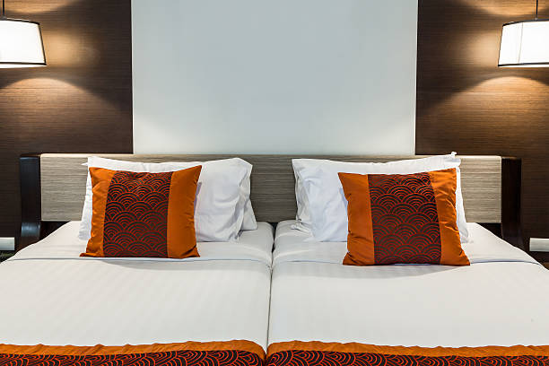 istock Red pillow on bedroom with white bedsheet and lamp light 518250682