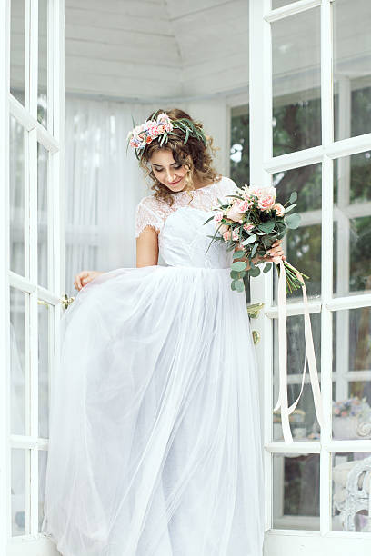 istock bride stands with a bouquet 518251956