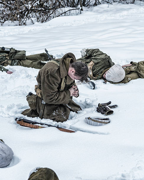 istock WWII Soldier Praying For Dead Combat Buddies 518252432