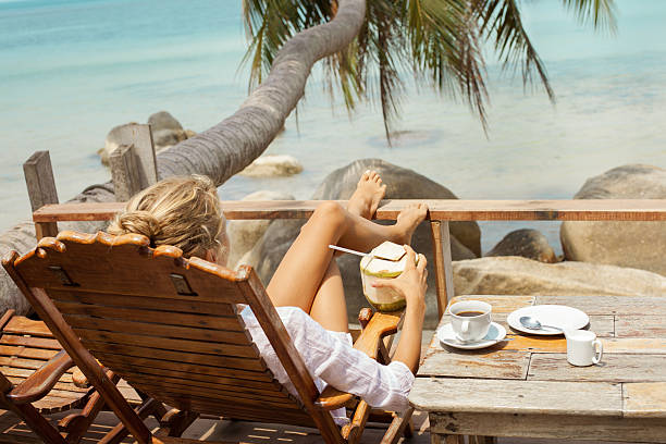 istock Young woman enjoys drinking coffee and coconut 518252520