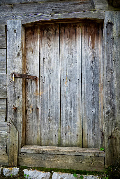istock Closed wooden doors with the metallic latch 518256995