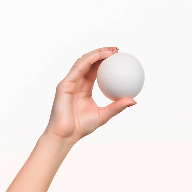 istock The female hand holding white blank styrofoam ball 518257242