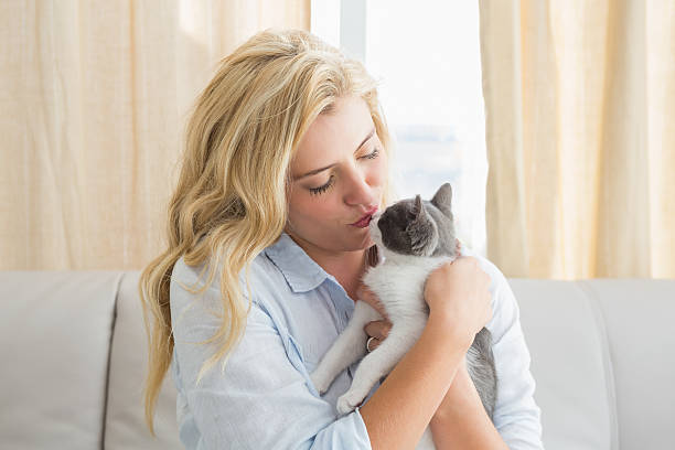 istock Pretty blonde with pet kitten on sofa 518257249